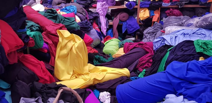 multi colored pile of fabrics, fabric for sewing clothing, fashionable fabric and textile industry