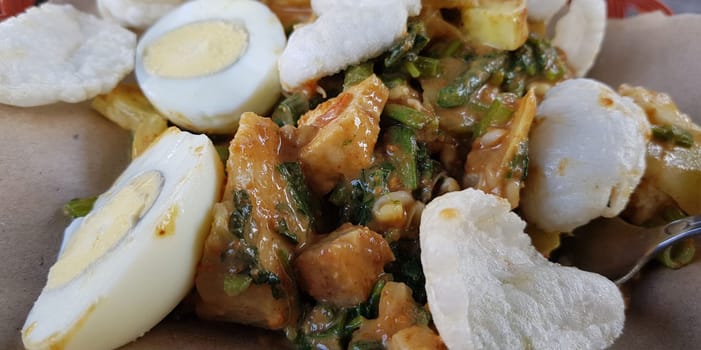 CNN winning top food, Typical Indonesian healthy food, often called gado gado, or lotek, consists of various vegetables, eggs, tempeh, and lontong with peanut sauce, street food