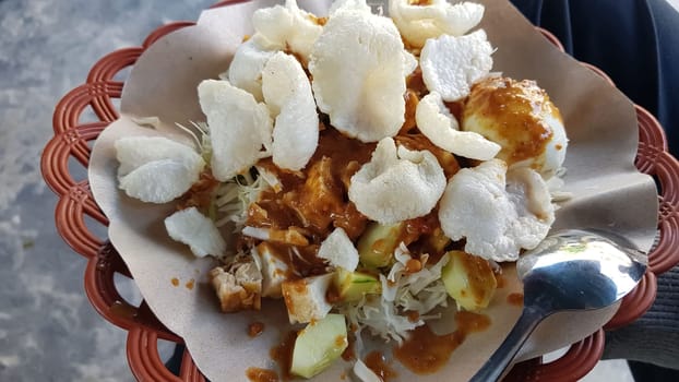 CNN winning top food, Typical Indonesian healthy food, often called gado gado, or lotek, consists of various vegetables, eggs, tempeh, and lontong with peanut sauce, street food
