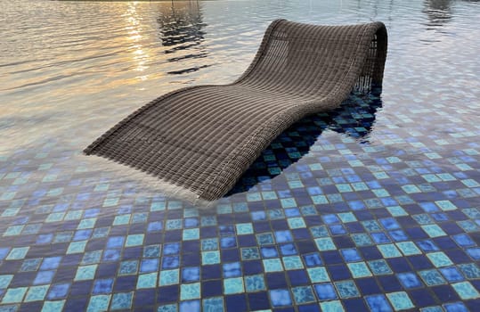 relax deck chair by the blue pool at swimming pool in luxury spa resort or villa Tourism industry crisis after covid 19 coronavirus pandemic Travel lifestyle on family summer vacation