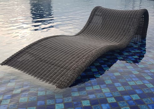 relax deck chair by the blue pool at swimming pool in luxury spa resort or villa Tourism industry crisis after covid 19 coronavirus pandemic Travel lifestyle on family summer vacation