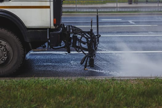 Cleaning sweeper machines washes the city asphalt road 