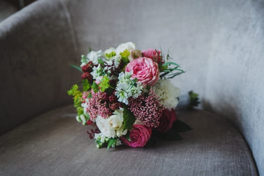 fresh wedding bouquet on the chair. wedding preparations