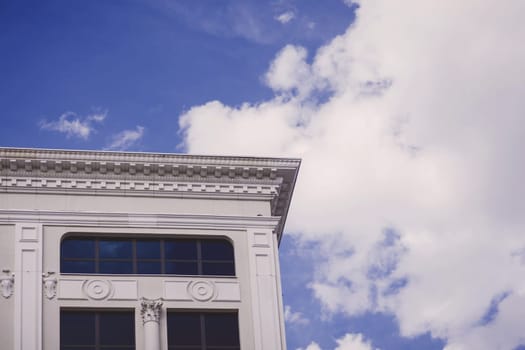 modern building with imitation of antique style on sky background