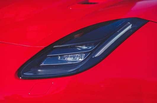 Car headlight. red color auto