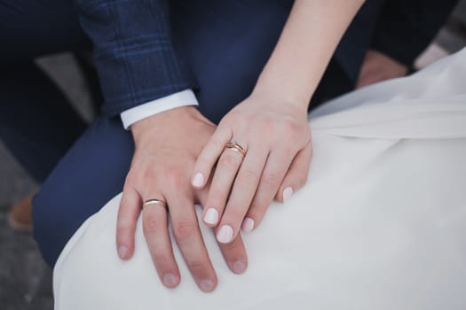 Newly wed couple's hands with wedding rings
