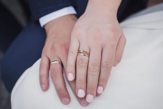 Close-up hands of man and woman with wedding ring