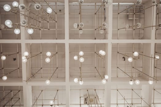 many light bulbs on the ceiling of the office space