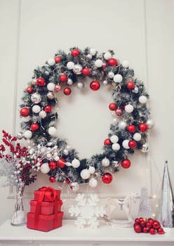 New Year and Christmas 2020. Christmas apartment with a fireplace, beautiful tree with balls