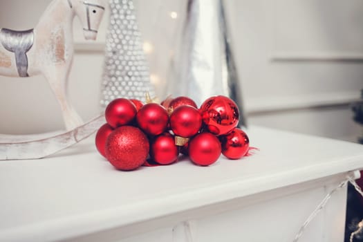 red Christmas balls are on the shelf