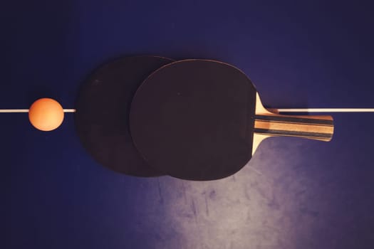 Ping pong table, two rackets and balls in a sport hall