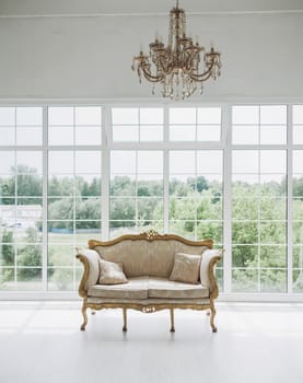 classic interior of the living room with a sofa and a large window