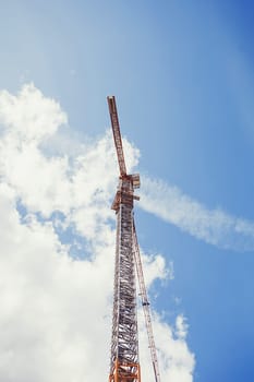 Large construction crane with a blue sky on the background.