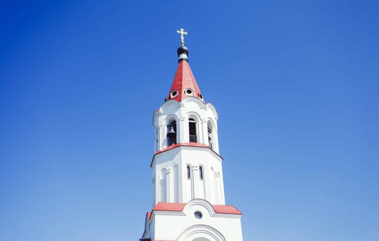 Church building with a cross against the blue sky