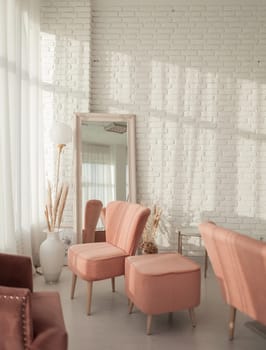 Living room with sofa, armchair, lamp and brick wall