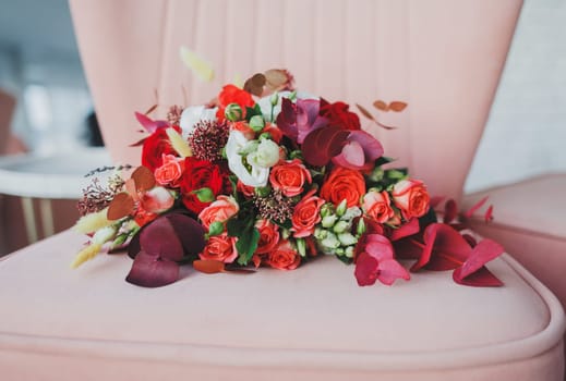 bright bouquet of wedding flowers on a chair. flowers for the bride