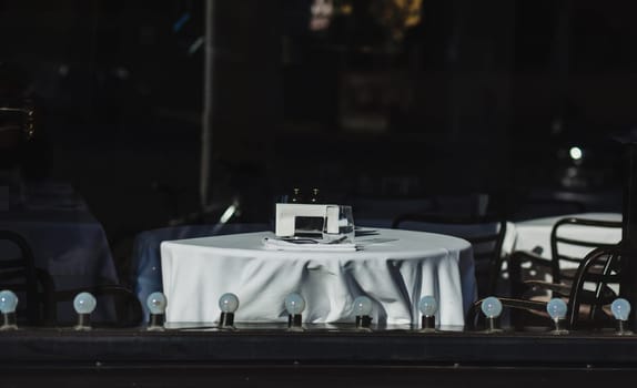 Public restaurant in the city center. cafe window with a table and a white tablecloth