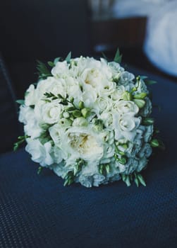 Wedding bouquet of red and white roses on the chair