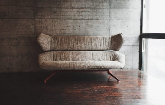 stylish spare room with sofa and large window in loft style