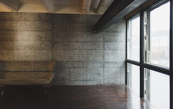 loft interior with sofa in grey. brutal apartment