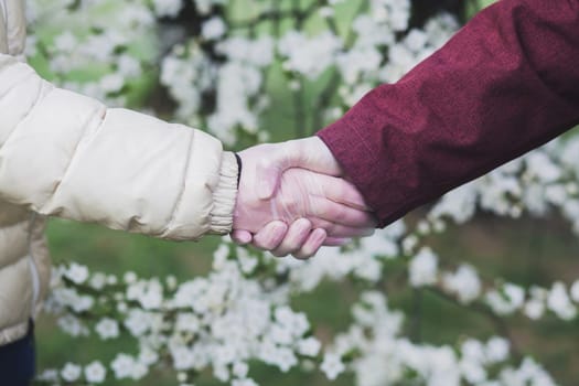 Greeting to avoid the spread of coronavirus. Two friends meet in gloves.