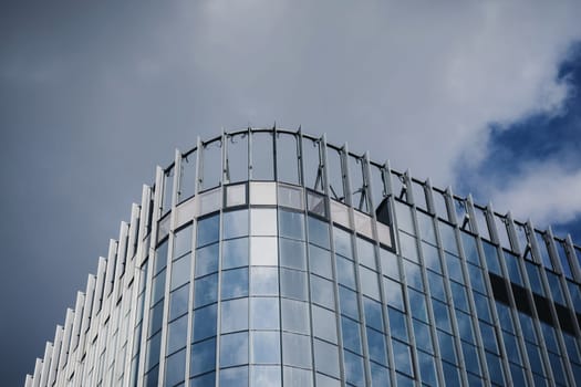 Modern glass office building over sky background