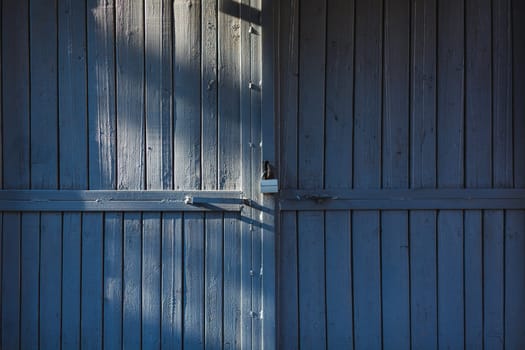 old wooden gate with metal lock