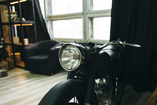Close up shot of a vintage motorcycle headlight in room