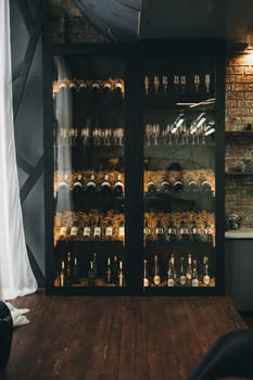 Glass wine cabinet in the classic interior of a man's apartment