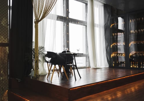 Modern minimalistic dark loft style studio apartment interior design. Sitting area, workplace