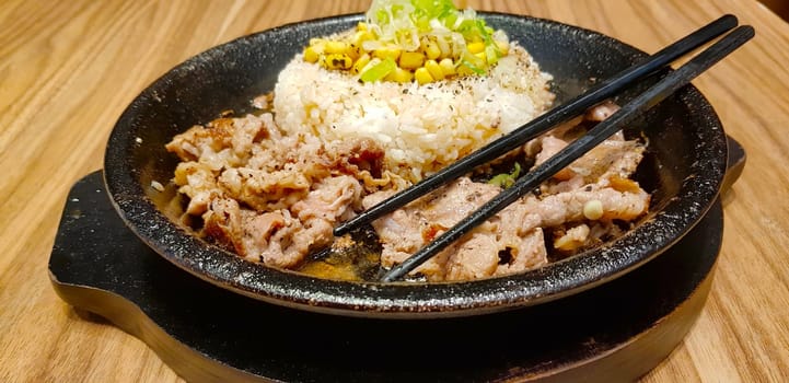 selective focus grilled beef steak with korean sauce bulgogi on top of rice with slice of pepper and sweet corn - korean food style