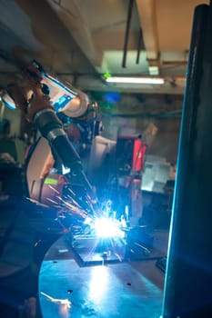 Image of robotic machine welding metal fasteners, close-up