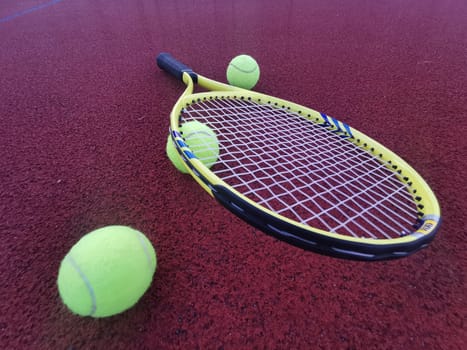 Tennis racket and ball on a hard tennis court. High quality photo
