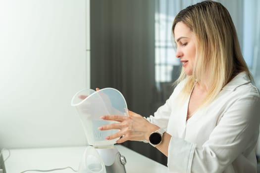 sick middle-aged woman breathing with inhaler portrait. High quality photo