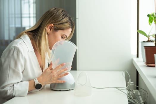 Woman has a bad cold and is trying therapy by inhaler. High quality photo