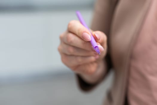 Using a hand hold the pen for writing. High quality photo