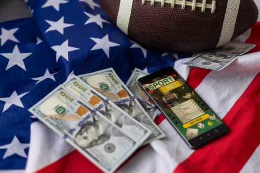 rugby ball and dollars with usa flag and smartphone bet. High quality photo