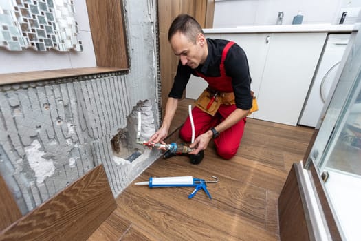 Plumber working in the bathroom. High quality photo