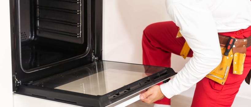 man assembling an electric oven.