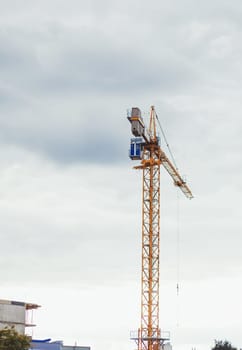 yellow tower crane on sky background.