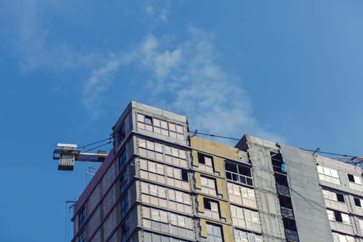 construction site with crane against the blue sky