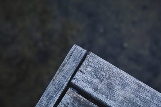 fragment of an old wooden pier on the lake