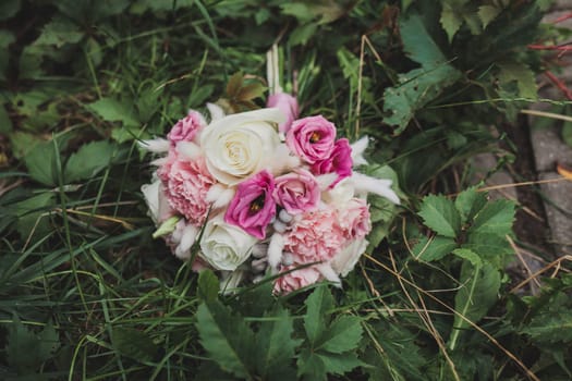 wedding bouquet of the bride in the grass