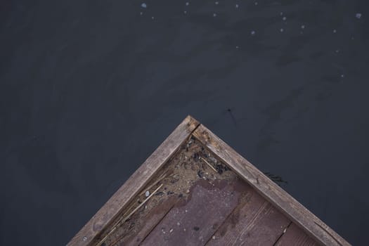 corner of a wooden pier on the background of the lake