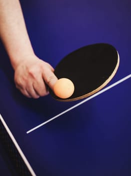 ping pong player hits a ball with a racket