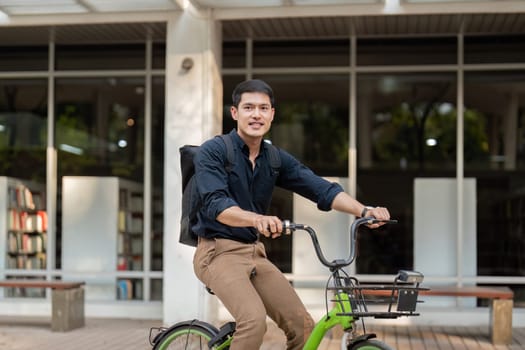 Businessman and bicycle in city to work with eco friendly transport. happy businessman professional riding a bicycle in urban street.