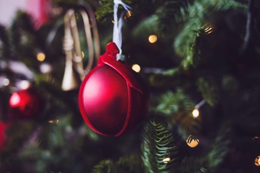 red christmas ball hanging on the tree.