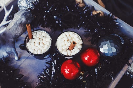 two mugs of cocoa with marshmallows on the Christmas table