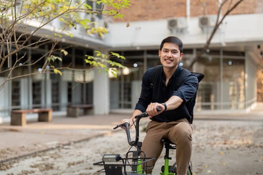 Businessman and bicycle in city to work with eco friendly transport. happy businessman professional riding a bicycle in urban street.