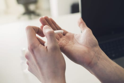 man puts a protective antibacterial gel on his hands. concept of health and cleanliness